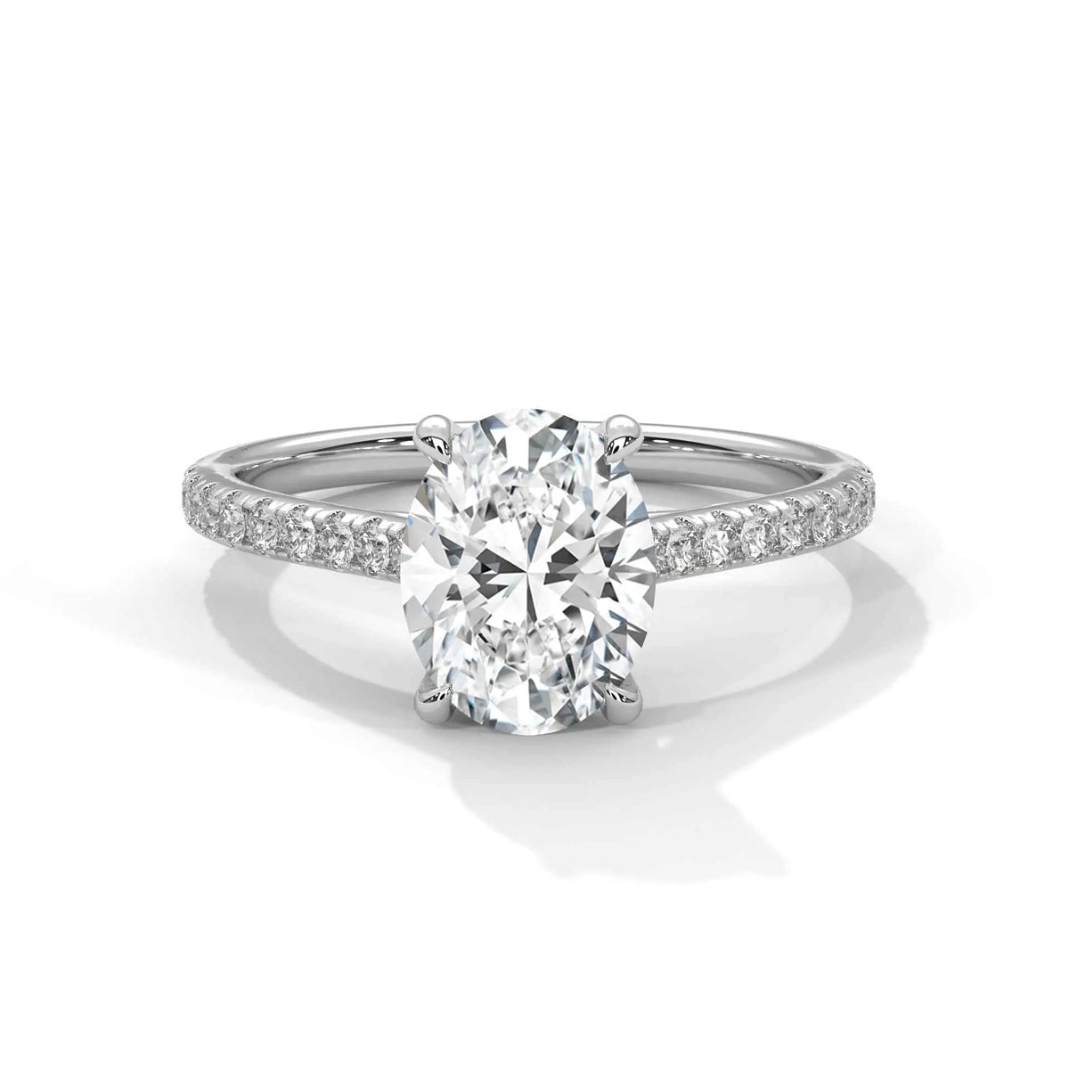 Oval center diamond ring in white gold with pavé band and four-prong setting