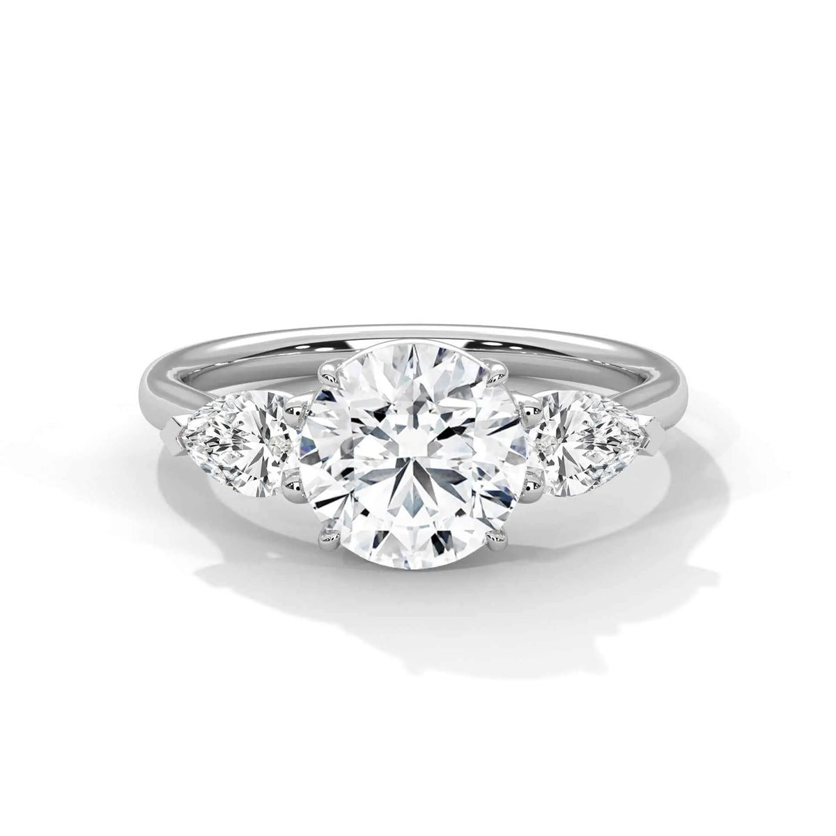 Three-stone diamond ring in platinum with a round center stone and two side stones