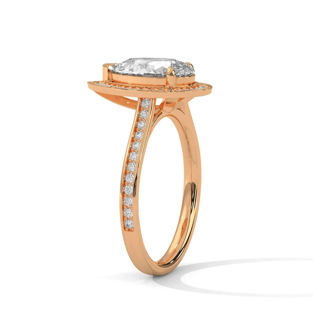 Pear halo diamond ring in rose gold, side view with prong-set stone and pavé band.