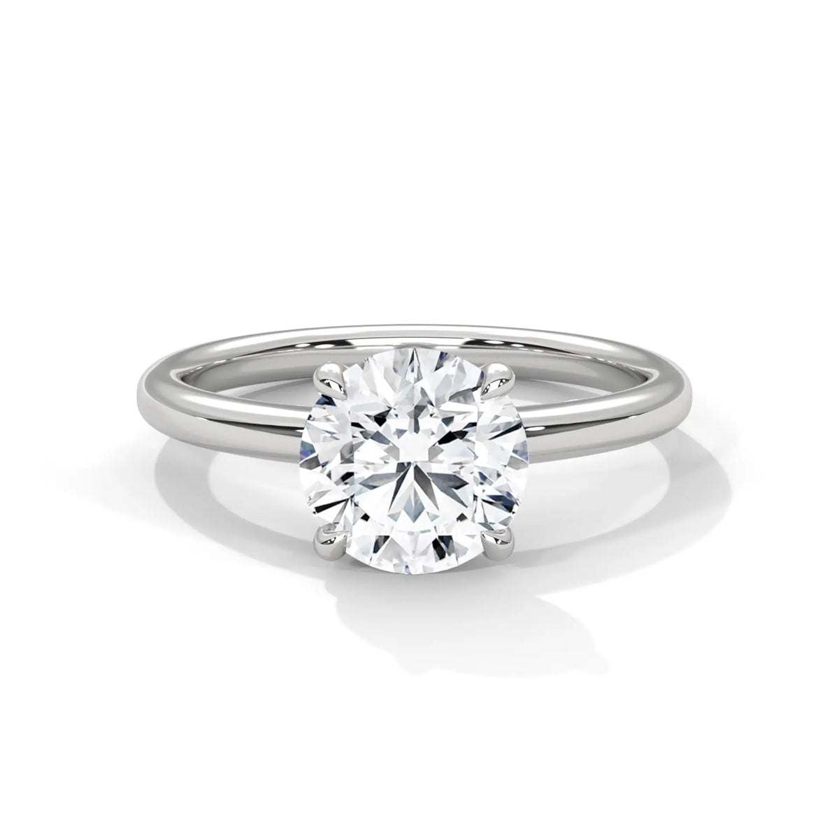 White metal solitaire engagement ring with round diamond and slim band