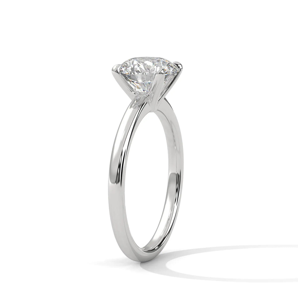 White metal solitaire ring with round center diamond, four-prong basket setting