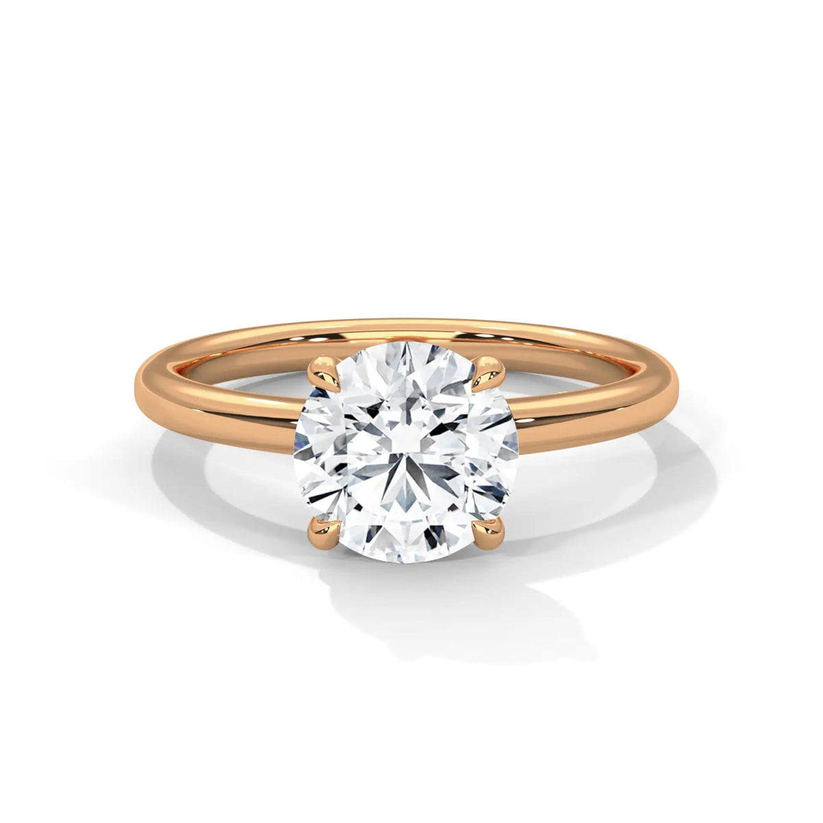 Yellow gold solitaire engagement ring with round diamond in four-prong setting