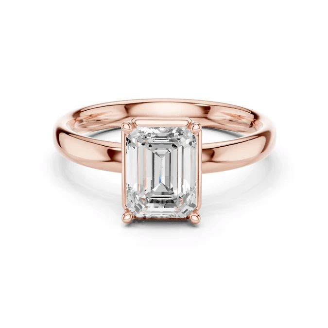 Rose gold emerald-cut solitaire diamond ring with four-prong center stone