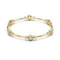 Gold bangle with round diamond floral cluster and small side stones