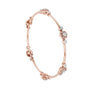 Rose gold diamond bangle side view with round cluster details along the cuff.