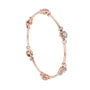 Rose gold diamond bangle side view with round cluster details along the cuff.
