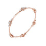 Rose gold diamond bangle bracelet viewed from the side, showing round stone clusters.