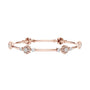 Rose gold diamond bangle with round cluster floral accents and hinged link design.