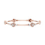 Rose gold diamond bangle with round cluster floral accents and hinged link design.