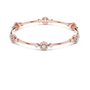 Rose gold diamond bangle bracelet with floral cluster links and round stones at accents.