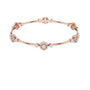Rose gold diamond bangle bracelet with floral cluster links and round stones at accents.