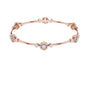 Rose gold diamond bangle bracelet with floral cluster links and round stones at accents.
