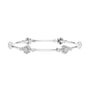 White gold round diamond bangle with floral cluster accents and slim bar design.
