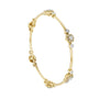 Yellow gold diamond bangle with round cluster floral accents and hinged links.
