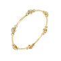 Yellow gold diamond bangle viewed from the side with round cluster accents.