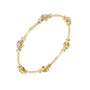 Yellow gold diamond bangle viewed from the side with round cluster accents.