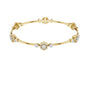 Yellow gold round diamond bangle with floral clusters along the slim cuff.