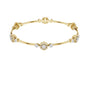 Yellow gold round diamond bangle with floral clusters along the slim cuff.