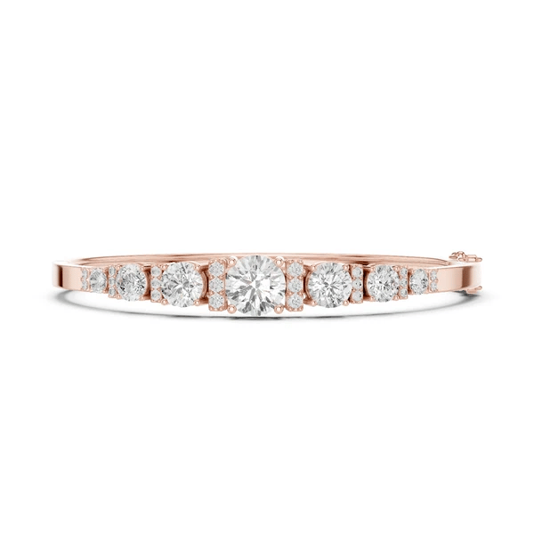Rose gold graduated diamond bangle with seven round stones