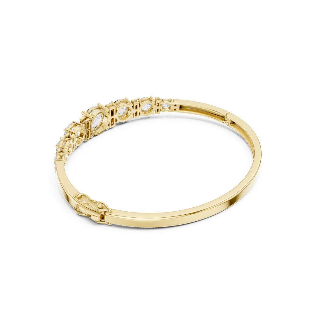Yellow gold graduated diamond bangle with seven round stones