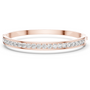 Rose gold channel-set diamond bangle with round stones, hinged fit.
