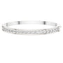White gold channel-set diamond bangle with round stones, hinged fit.