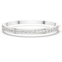 White gold channel-set diamond bangle with round stones, hinged fit.