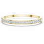 Yellow gold channel-set diamond bangle with round stones, hinged fit.