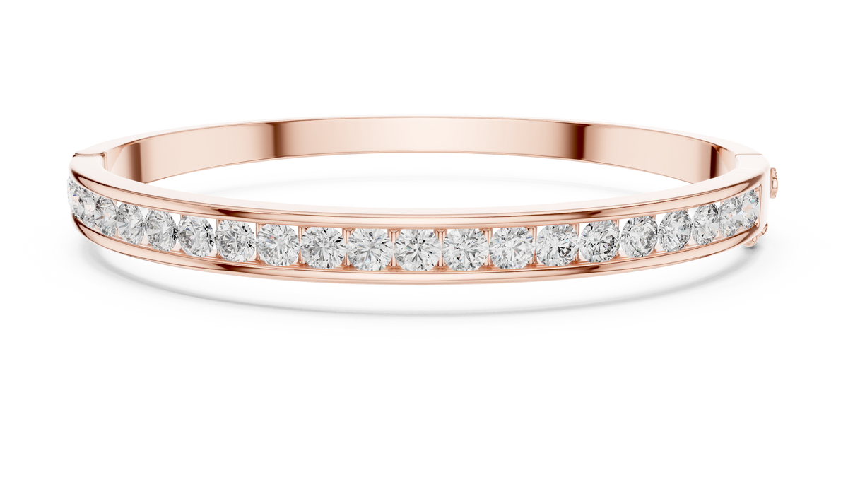 Yellow gold channel-set diamond bangle with round stones, full front view.