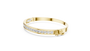 Diamond channel-set bangle with yellow-gold band and round stones along the front
