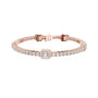 Rose gold tennis bracelet with emerald-cut halo centerpiece and diamond pavé links