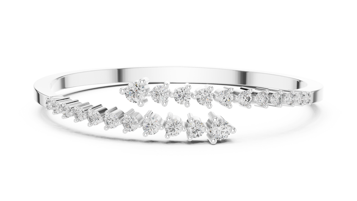 White gold bypass bangle with round diamond pavé accents.