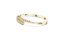 Yellow gold bypass bangle with round diamond pavé accents, angled view.