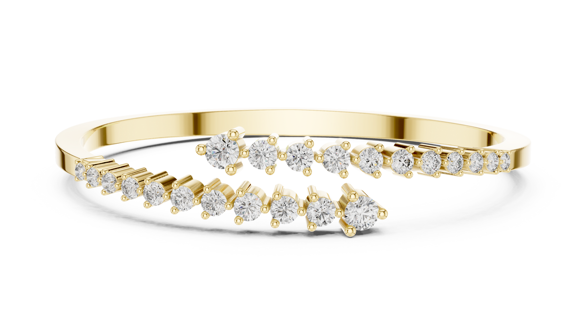 Yellow gold bypass bangle with round diamond pavé accents.