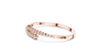 Rose gold bypass bangle with round diamond pavé accents, angled view.