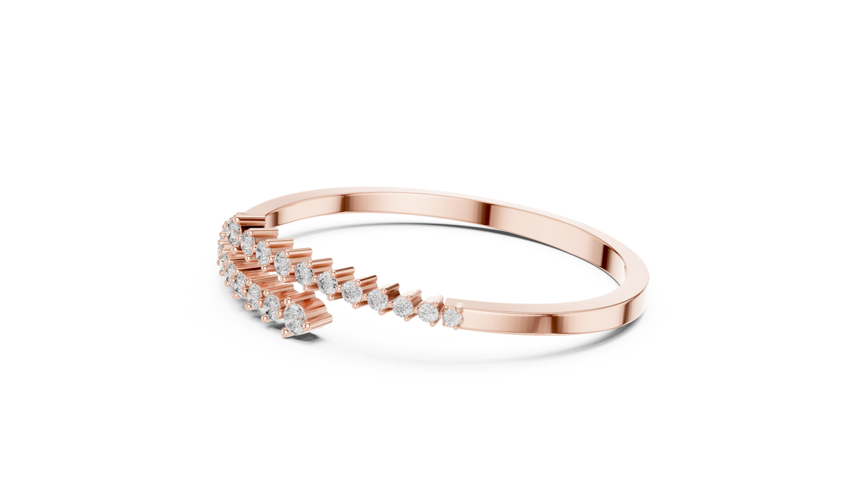 Rose gold bypass bangle with round diamond pavé accents, angled view.