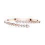 Rose gold bypass bangle with round diamond pavé accents.