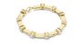 Yellow gold diamond chain bracelet with five round solitaire diamonds on the band.