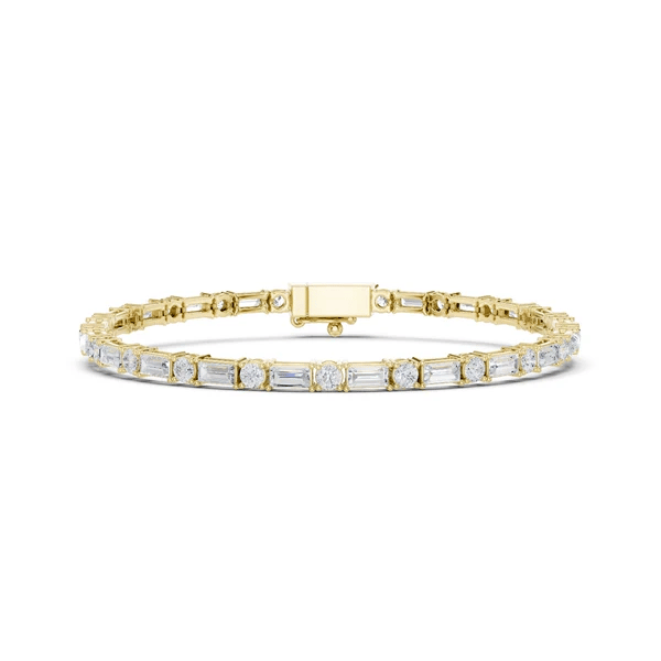 Two-tone diamond bracelet with yellow gold frame and mixed-cut stones in bezels.