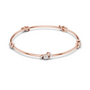 Rose gold diamond bangle with round center stone and linked diamond accents