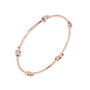 Rose gold diamond bangle with prong-set round stones, angled side view