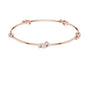 Rose gold diamond bangle with three round stone accents, angled flat view