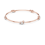Rose gold diamond bangle with three round stone accents, angled flat view