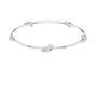 White gold diamond bangle with three round stone accents, front flat view