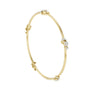 Yellow gold diamond bangle with round-cut stones, oval bracelet profile