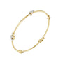 Yellow gold diamond bangle with round-cut stones, angled oval bracelet view