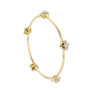 Yellow gold floral diamond bangle with four flower charms and round diamond centers
