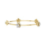 Yellow gold floral diamond bangle with three slender bands and flower center clusters