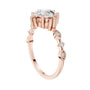 Rose gold engagement ring side view with round diamonds on the split shank