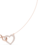 Rose gold diamond heart love knot necklace detail with heart drop charm